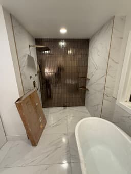 Modern bathroom with large format tiles and smart lighting